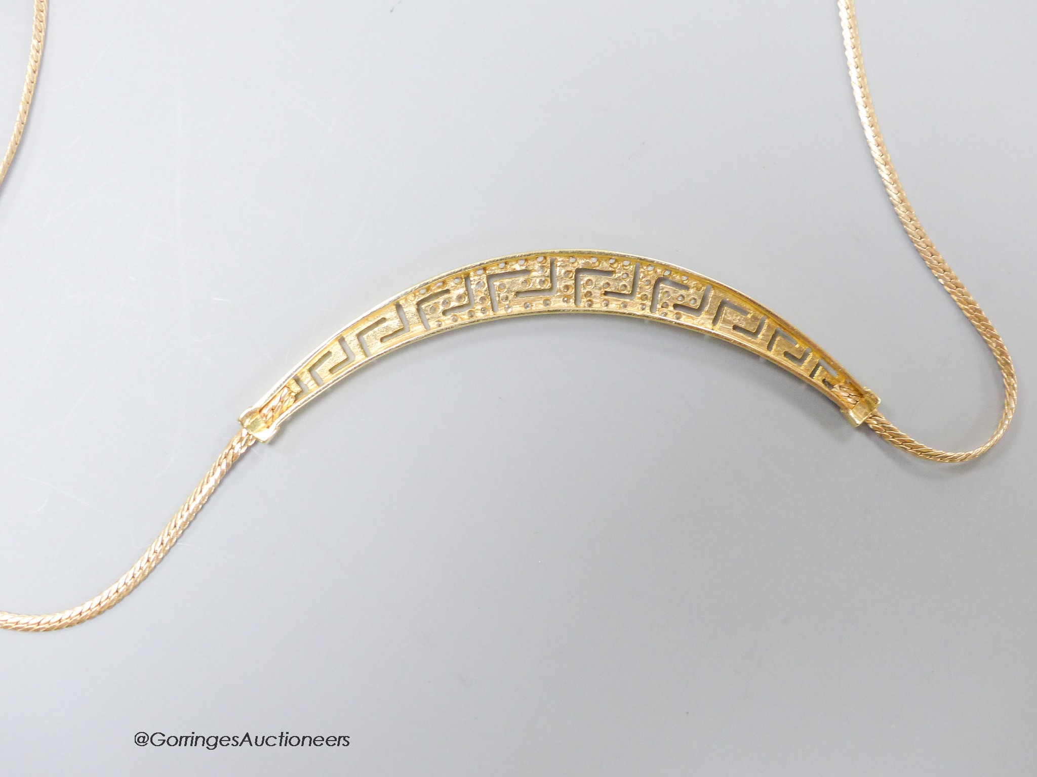 A modern 585 yellow metal and white stone set 'Greek key' pattern necklace, approx. 40cm, gross 8.2 grams.